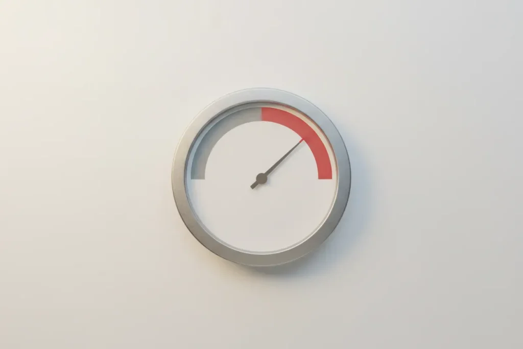 Minimalist gauge with needle crossing into a red zone on a soft neutral background, symbolizing a decision threshold.
